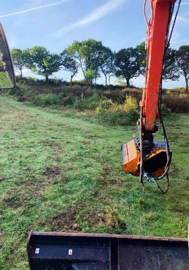 Excavator with mulching head clearing overgrown land in Essex
